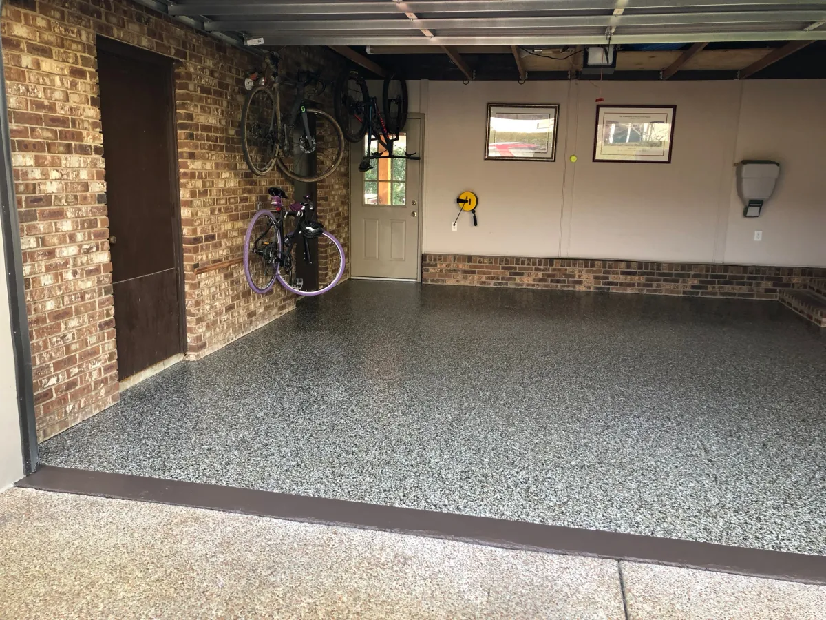 Finished garage floor coating with black white gray and red flakes